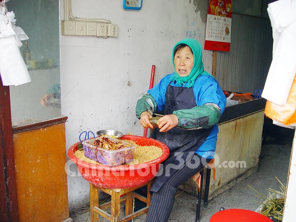 A woman is making local snack